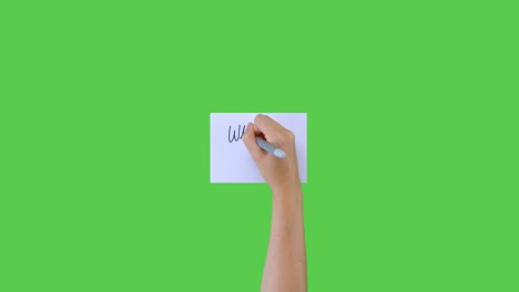 Woman-Writing-What-Is-Bitcoin-In-Cursive-on-Paper-with-Green-Screen