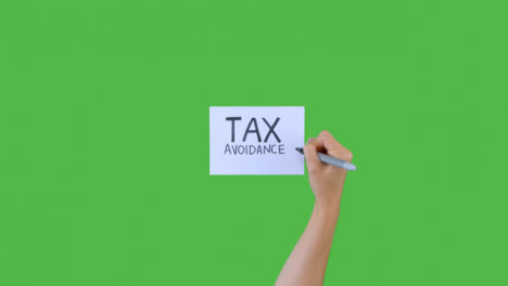 Woman-Writing-Tax-Avoidance-on-Paper-with-Green-Screen-01