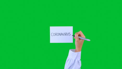 Doctor-Writing-Coronavirus-on-Paper-with-Green-Screen