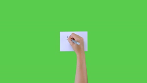 Woman-Writing-Social-Distancing-on-Paper-with-Green-Screen