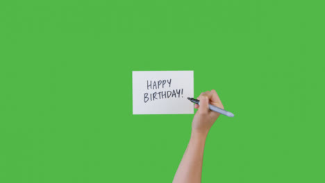 Woman-Writing-Happy-Birthday-on-Paper-with-Green-Screen