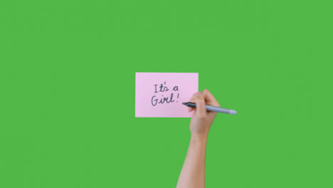 Woman-Writing-Its-A-Girl-on-Paper-with-Green-Screen