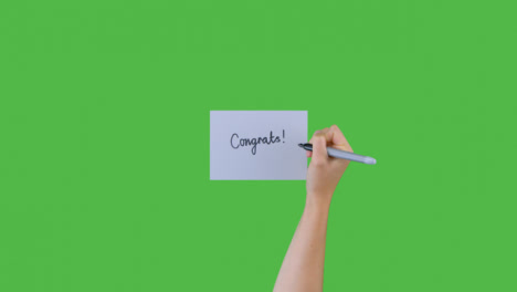 Woman-Writing-Congrats-on-Paper-with-Green-Screen
