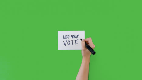 Mujer-Escribiendo-Usa-Tu-Voto-En-Papel-Con-Pantalla-Verde