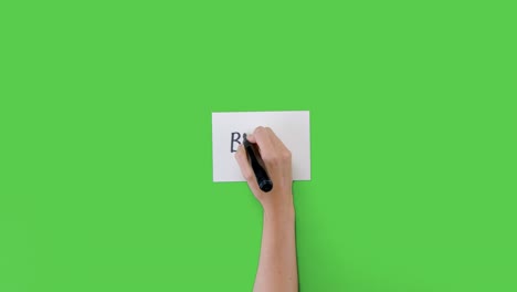 Woman-Writing-Brexit-on-Paper-with-Green-Screen