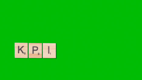 Stop-Motion-Business-Concept-Overhead-Shot-Wooden-Letter-Tiles-Forming-Acronym-KPI-On-Green-Screen-1