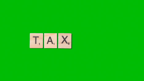 Stop-Motion-Business-Concept-Overhead-Wooden-Letter-Tiles-Forming-Word-Tax-On-Green-Screen-1