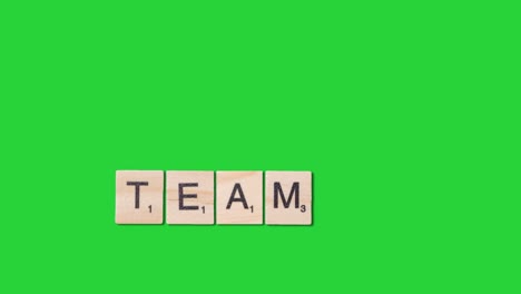 Stop-Motion-Business-Concept-Overhead-Wooden-Letter-Tiles-Forming-Word-Team-On-Green-Screen-1