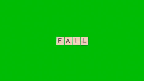 Stop-Motion-Business-Concept-Overhead-Wooden-Letter-Tiles-Forming-Word-Fail-On-Green-Screen