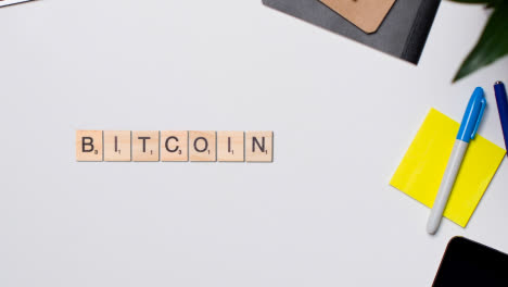 Stop-Motion-Business-Concept-Above-Desk-Wooden-Letter-Tiles-Forming-Word-Bitcoin-1