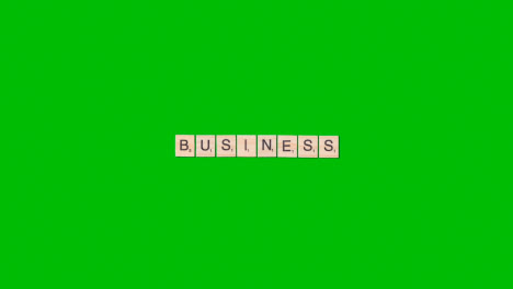 Stop-Motion-Business-Concept-Overhead-Wooden-Letter-Tiles-Forming-Word-Business-On-Green-Screen