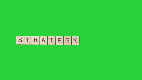 Stop-Motion-Business-Concept-Overhead-Wooden-Letter-Tiles-Forming-Word-Strategy-On-Green-Screen-1