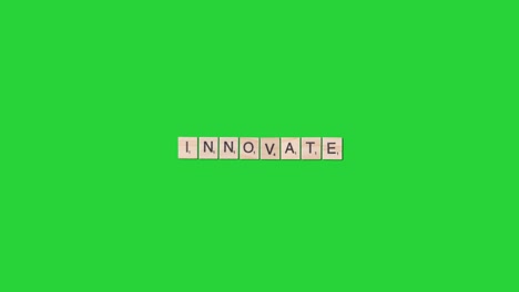 Stop-Motion-Business-Concept-Overhead-Wooden-Letter-Tiles-Forming-Word-Innovate-On-Green-Screen