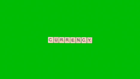 Stop-Motion-Business-Concept-Overhead-Wooden-Letter-Tiles-Forming-Word-Currency-On-Green-Screen