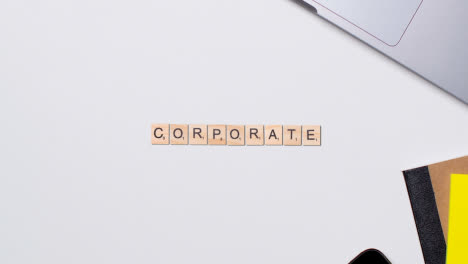 Stop-Motion-Business-Concept-Above-Desk-Wooden-Letter-Tiles-Forming-Word-Corporate