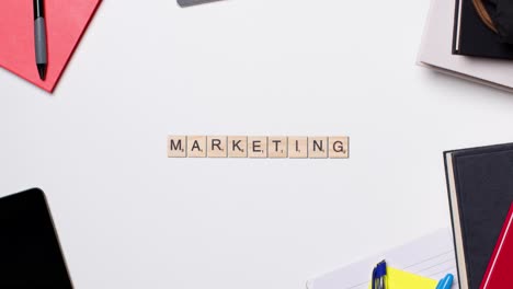 Stop-Motion-Business-Concept-Above-Desk-Wooden-Letter-Tiles-Forming-Word-Marketing