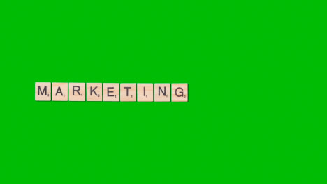 Stop-Motion-Business-Concept-Overhead-Wooden-Letter-Tiles-Forming-Word-Marketing-On-Green-Screen-1