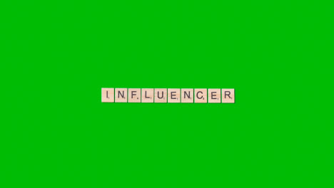Stop-Motion-Business-Concept-Overhead-Wooden-Letter-Tiles-Forming-Word-Influencer-On-Green-Screen