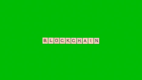 Stop-Motion-Business-Concept-Overhead-Wooden-Letter-Tiles-Forming-Word-Blockchain-On-Green-Screen