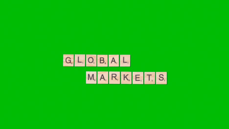 Stop-Motion-Business-Concept-Overhead-Wooden-Letter-Tiles-Forming-Words-Global-Markets-On-Green-Screen