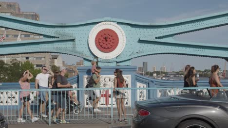 Summer-Tourists-Walking-Across-Tower-Bridge-London-England-UK-With-Traffic-3