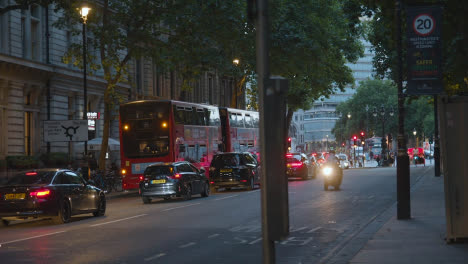 Evening-Traffic-With-Buses-And-Cars-On-Busy-London-England-UK-Street-At-Dusk