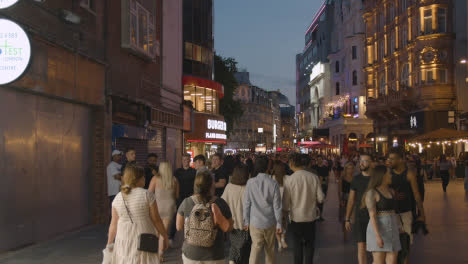 Crowd-Of-Summer-Tourists-Walking-In-Leicester-Square-At-Dusk-In-London-England-UK-2