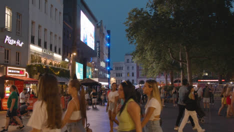 Crowd-Of-Summer-Tourists-Walking-In-Leicester-Square-At-Dusk-In-London-England-UK-5