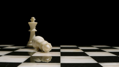 Studio-Shot-Of-Chess-Board-Empty-Apart-From-White-King-And-Queen-Pieces