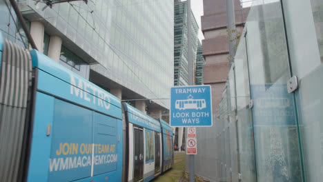 Tramway-Warning-Sign-With-Tram-In-Birmingham-UK
