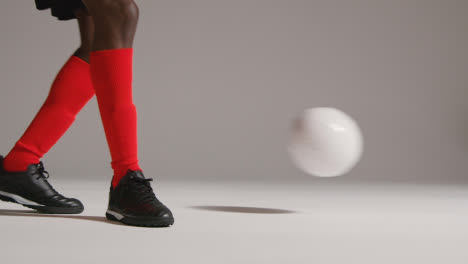 Close-Up-Of-Male-Footballer-In-Studio-Controlling-And-Passing-Ball-1
