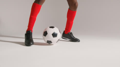 Close-Up-Of-Male-Footballer-In-Studio-Controlling-And-Passing-Ball-2