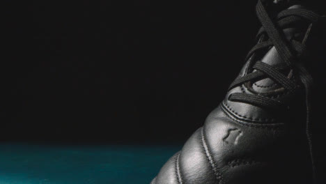 Studio-Still-Life-Shot-Of-Football-Soccer-Boots-Against-Black-Background-7
