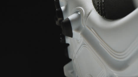 Studio-Still-Life-Close-Up-Shot-Of-Football-Soccer-Boot-With-Studs-Against-Black-Background-2