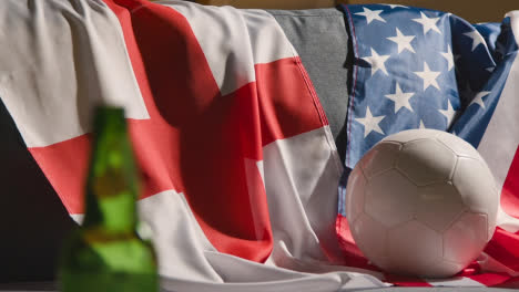 Sofa-In-Lounge-With-English-And-American-Flags-And-Ball-As-Fans-Prepare-To-Watch-Football-Soccer-Match-On-TV-1