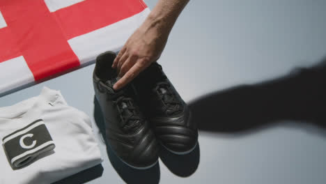 Studio-Still-Life-Shot-Of-Football-Soccer-Boots-English-Flag-Shirt-And-Shorts-And-Captains-Armband-1