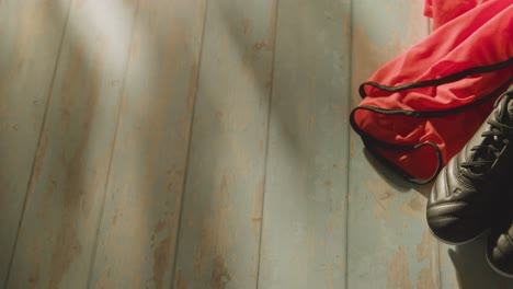 Studio-Still-Life-Shot-Of-Football-Soccer-With-Boots-Ball-And-Training-Bib-In-Dressing-Room-3