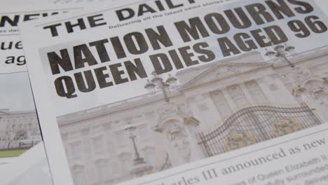Tracking-Close-Up-of-Newspaper-Headlines-of-Queen-Elizabeths-Death-01