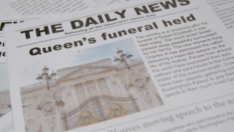 Tracking-Close-Up-of-Newspaper-Headlines-of-Queen-Elizabeths-Death-04