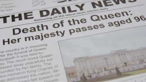 Tracking-Close-Up-of-Newspaper-Headlines-of-Queen-Elizabeths-Death-05