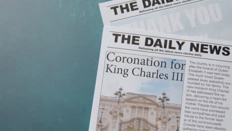 Tracking-Shot-of-King-Charles-III-Coronation-Newspaper-Headlines-with-Copy-Space