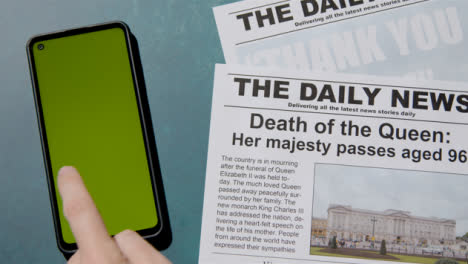 Top-View-of-Queen-Elizabeth-Death-Newspaper-Headlines-with-Green-Screen-Phone-02