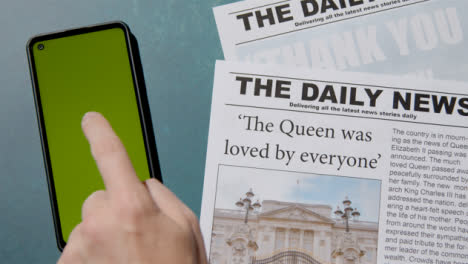 Top-View-of-Queen-Elizabeth-Death-Newspaper-Headlines-with-Green-Screen-Phone-03