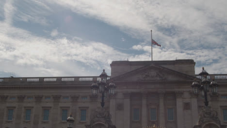 Panning-Shot-of-Buckingham-Palace's-United-Kingdom-Flag-Flying-at-Half-Mast