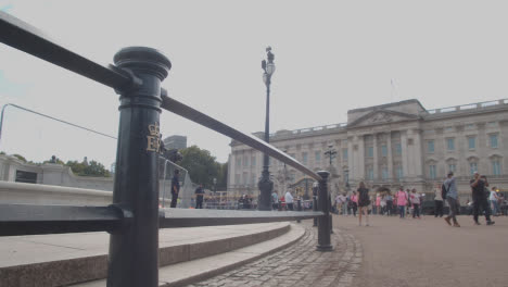 Low-Angle-Shot-of-Walking-Crowd-Outside-of-Buckingham-Palace-In-London