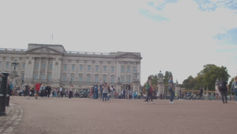 Low-Angle-Shot-of-Walking-Crowds-Outside-of-Buckingham-Palace-In-London
