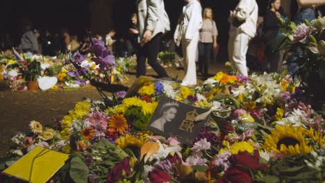 Close-Up-Shot-of-Floral-Tributes-and-Mourners-In-London's-Green-Park-05