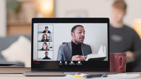 Man-Joining-Virtual-Video-Business-Meeting-On-Laptop-At-Home-2