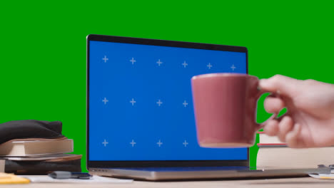 Blue-Screen-Laptop-With-Books-On-Table-With-Green-Screen-Background-Education-Concept-3