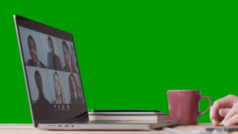 Person-Joining-Virtual-Video-Business-Meeting-On-Laptop-Against-Green-Screen